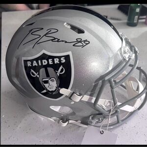Raiders full speed helmet signed by Brock Bowers. Gold bag